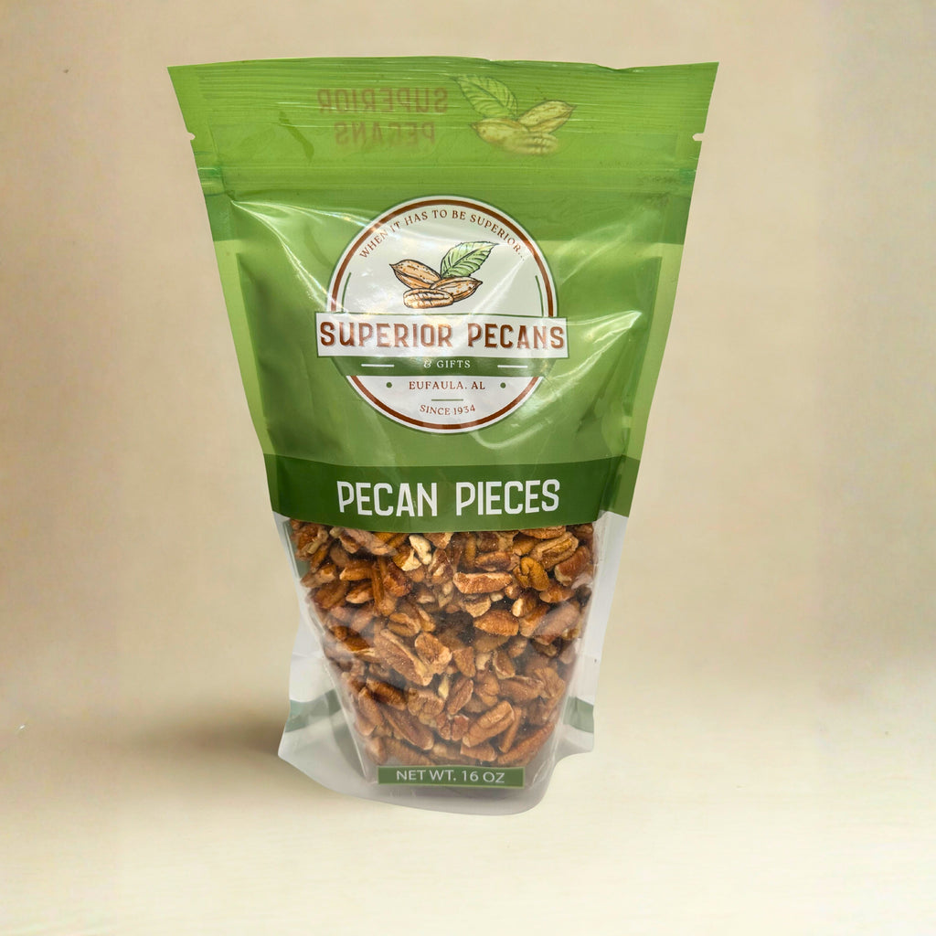 Green bag of Superior Pecans pecan pieces on a beige background